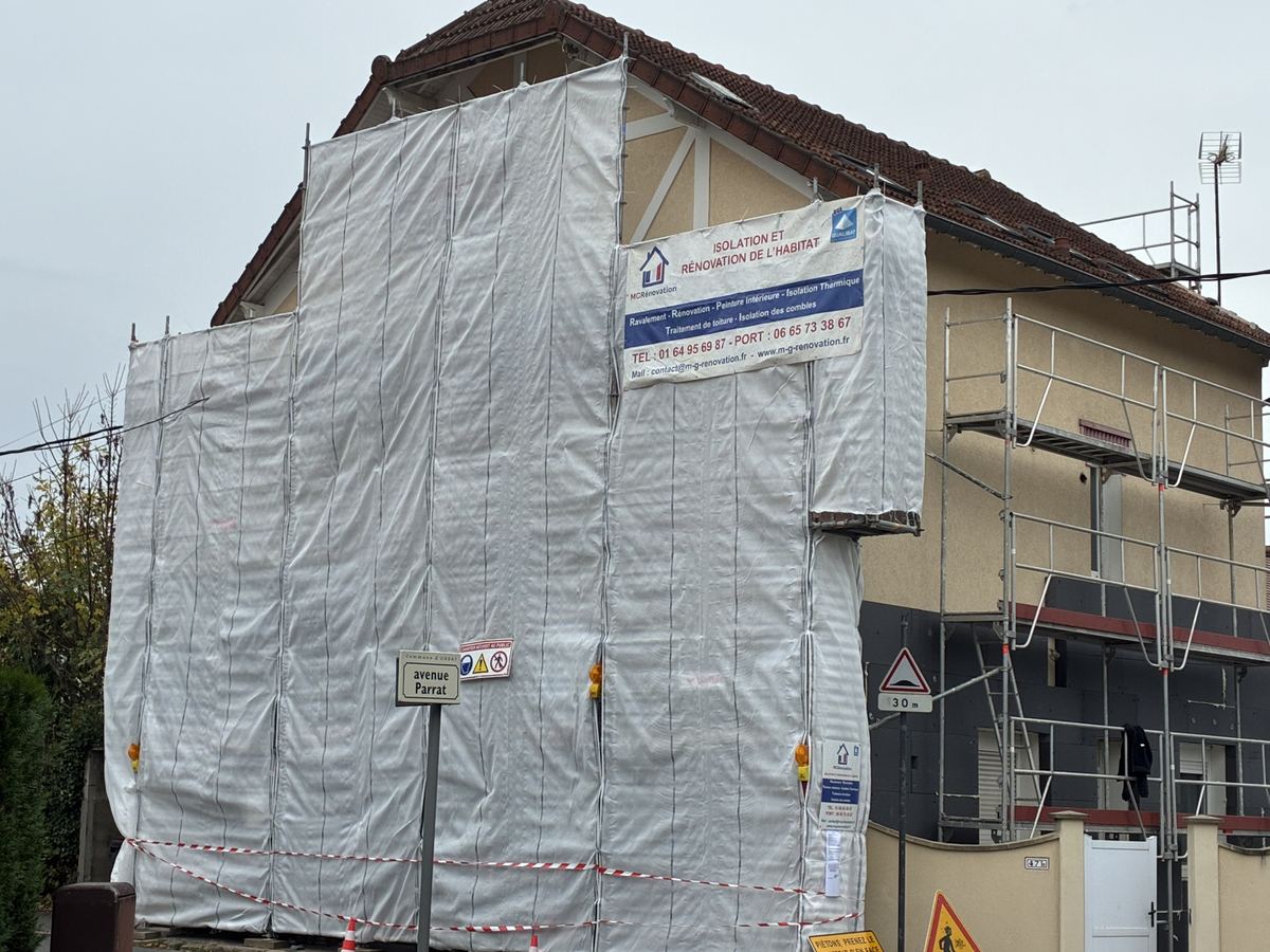 Échafaudage bâché et panneau de chantier MG Rénovation sur une façade à Orsay
